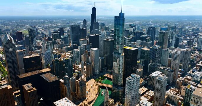 Slow descending over the stunning Chicago downtown. A big boat floats by the Chicago River.