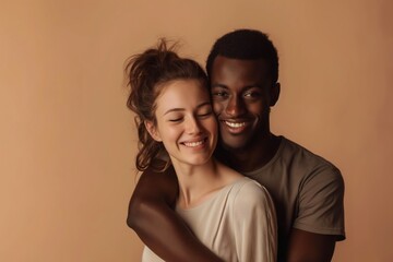 Fototapeta premium A man and a woman are hugging each other. The woman is smiling and the man is smiling as well. Scene is happy and loving