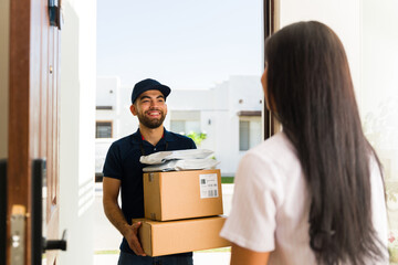 Smiling delivery man delivers packages to a customer's home, showcasing excellent service and...