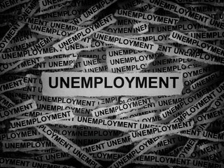 Strips of newspaper with the words Unemployment typed on them. Black and white. Close up.