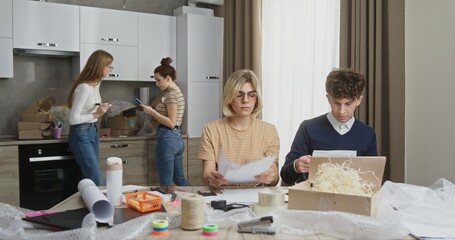 Dynamic Young Team Packaging Parcels for Small Business from Apartment