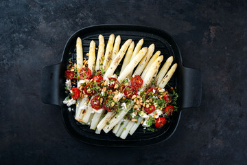 White asparagus caramelized with Greek feta cheese, tomatoes and roasted pine nuts served as top...