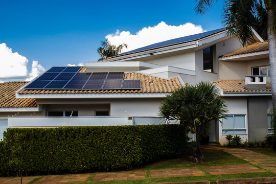 Residential house for high standard housing, with photovoltaic panels installed on the roof, for the production of electrical energy through sunlight, in Brazil