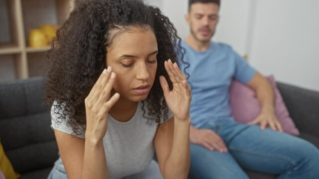 Worried woman and man having a discussion in a modern living room, portraying relationship issues, indoor stress, and contemplation.