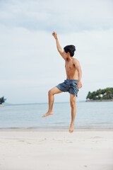 Serene Asian Athlete Enjoying Beach Workout: Muscular Man Running on Sand, Exuding Fitness and Wellness, Embracing Sea Freedom.