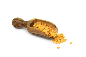 Toor dal or split yellow lentilsin a scoop isolated. Split Chickpea in a Bag Also Know as Chana Dal, Yellow Chana Split Peas, Dried Chickpea Lentils or Toor Dal isolated on white Background