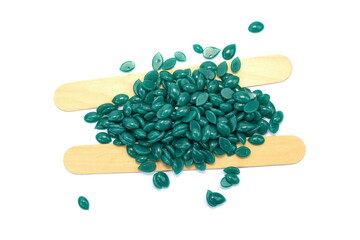 Waxing green granules aloe vera isolated on white background. Depilatory hard wax beans. Pearly wax granules from aloe vera. 