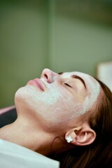 Naklejka premium A beautician performs cosmetic procedures on a girl's face