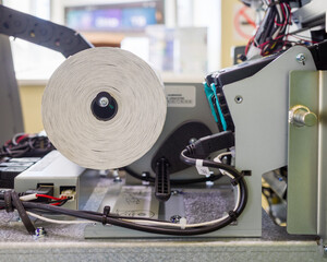 installing the receipt tape in the ATM's receipt printer. close-up.