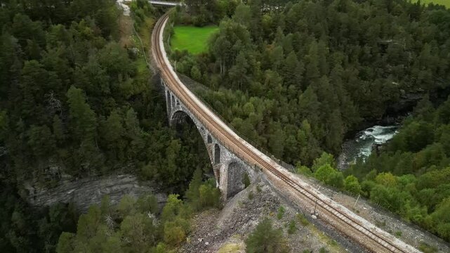 Scenic aerial reveal shot of Kylling railway bridge in Verma, Norway