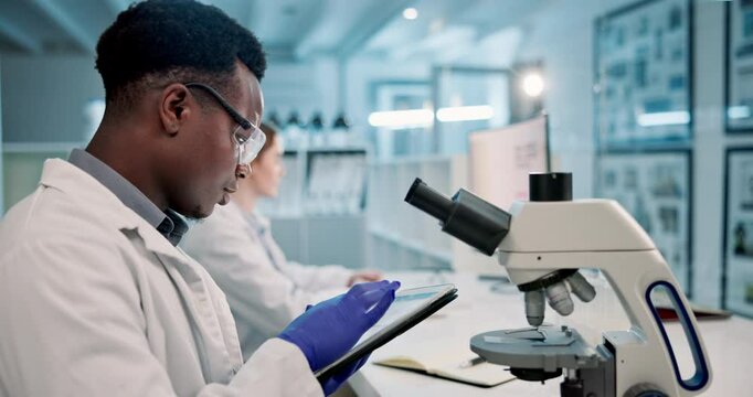 Science, laboratory and black man with microscope and tablet for online research, medical results and vaccine. Healthcare, biotechnology and scientist on digital tech for study, experiment and sample
