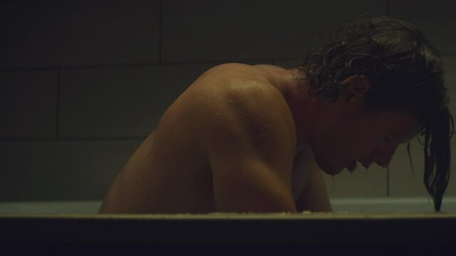 Athlete taking an ice bath and feeling tired