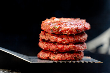 stack of grilled beef burger on spatula -  grilled