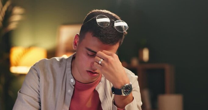 Stress, student and man in home at night with anxiety for university exams, studying and learning. College, education and male student in house with burnout, frustrated and headache for mistake
