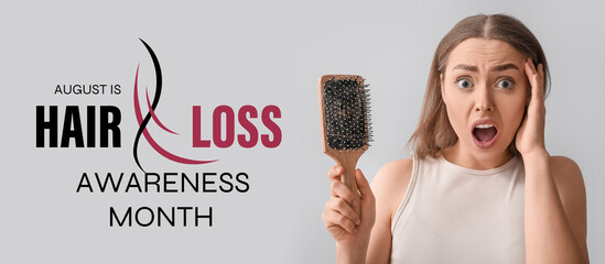 Stressed young woman with hair loss problem holding brush on light background