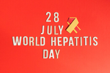 Yellow-red ribbon with wooden numbers July 28 World Hepatitis Day.