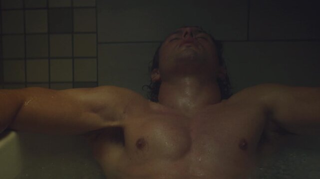 Athlete in bath tub full of ice