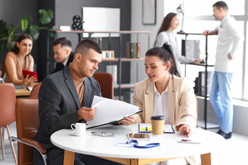 Business people negotiating at table in conference hall
