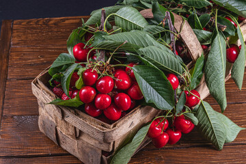 ripe cherries in a box on the table close up top view