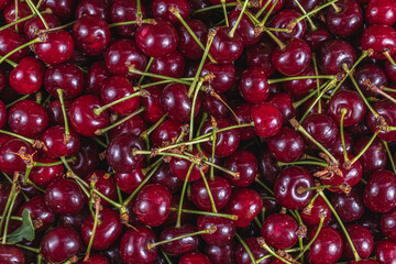 Ripe cherry in a plastic box on the table top view and side background