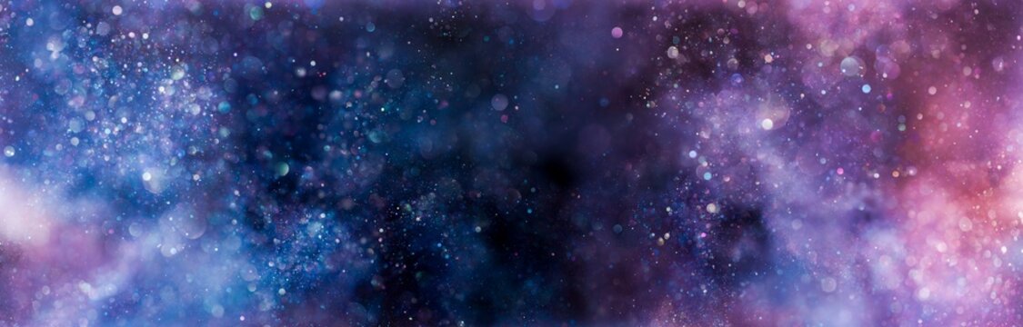 Sparkling lights glittering in ethereal blues purples and pinks. Magical galaxy or nebula background in vibrant dreamy colors.