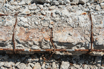 Reinforced concrete is broken and rusted.