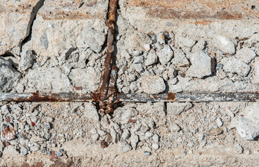 Reinforced concrete is broken and rusted.