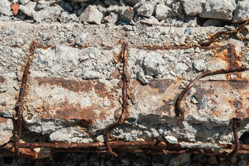 Reinforced concrete is broken and rusted.