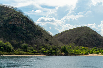 São Francisco River in Piranhas, state of Alagoas, northeast of Brazil. In the background, mountains and cloudy blue sky.