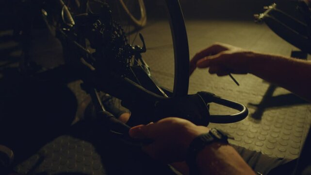 Para athlete in a garage adjusting his bicycle with special gear