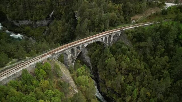Scenic aerial reveal shot of Kylling railway bridge in Verma, Norway