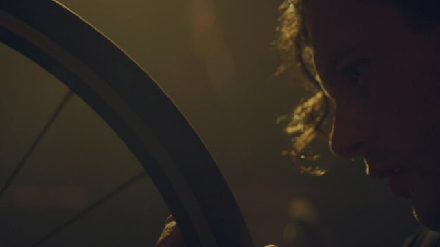 Para athlete in a garage calibrating the wheels on his bike