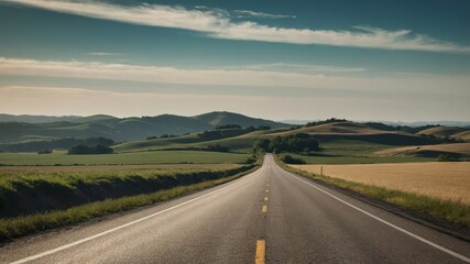 Naklejka premium Deserted countryside road with rolling hills under a vast sky, perfect for a journey theme