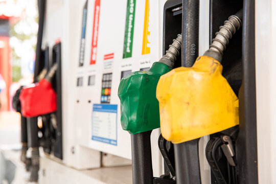 fuel pumps hanging at the bowser at a petrol station
