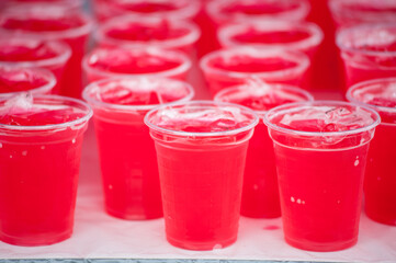 Red cold syrup in a plastic glass