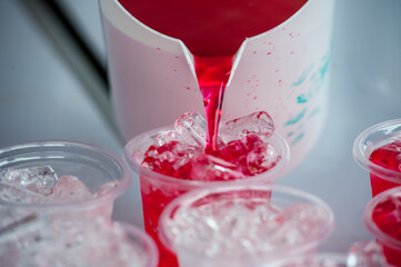 Red cold syrup in a plastic glass