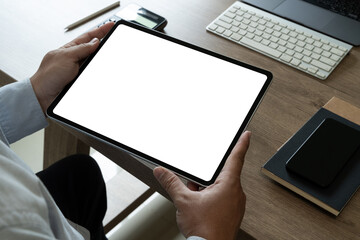 A businessman holds a mockup. iPad digital tablet with blank screen Mockup replaces your design...