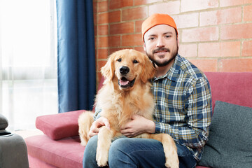portrait of a dog with his master looking at camera at home