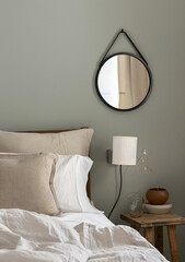 Minimalist Bedroom Interior Design with White Bedding and Round Mirror.