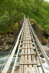 Fototapeta premium River, woods or landscape of mountains with bridge, natural environment or countryside in Norway. Zen nature, water or scenic view of Europe or valley for outdoor travel, holiday vacation or forest