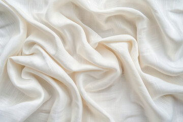 Fototapeta premium Close-up of silky white fabric with gentle folds and rich textures creating a soft and elegant texture, perfect for backgrounds and design elements.