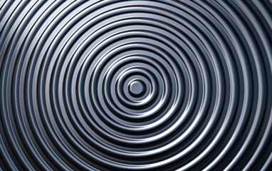 Close-up of concentric circles creating a mesmerizing abstract pattern with metallic texture, perfect for backgrounds or design elements.