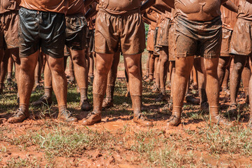 Police practice field training on muddy ground.
