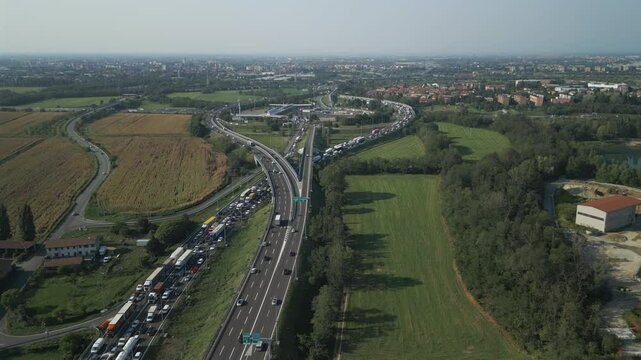 Aerial view of an Italian highway toll booth. Cars queuing up to pay the highway toll and automatic paying lanes.
