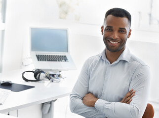 Businessman, portrait and smile with arms crossed in office for career confidence, workplace pride and entrepreneur. Professional, african employee and face at work desk for creative media company