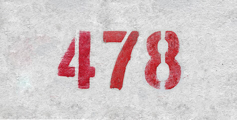 Red Number 478 on the white wall. Spray paint.