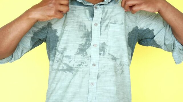 A detailed view of a man with sweat marks showcasing the impact of intense humidity