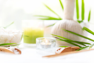 Select focus. Thai Spa Treatments aroma therapy salt and  sugar scrub massage with bamboo leaves with candle, white background. Thailand. Healthy Concept