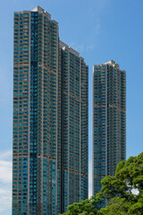 Tall glass and concrete buildings against a clear blue sky
