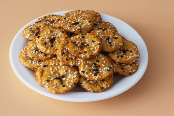 Close up of salted round pretzels with black and white sesame on a plate